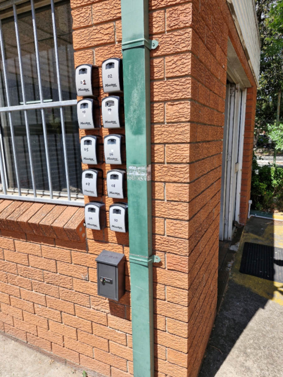Range of lockboxed on a orange brick wall