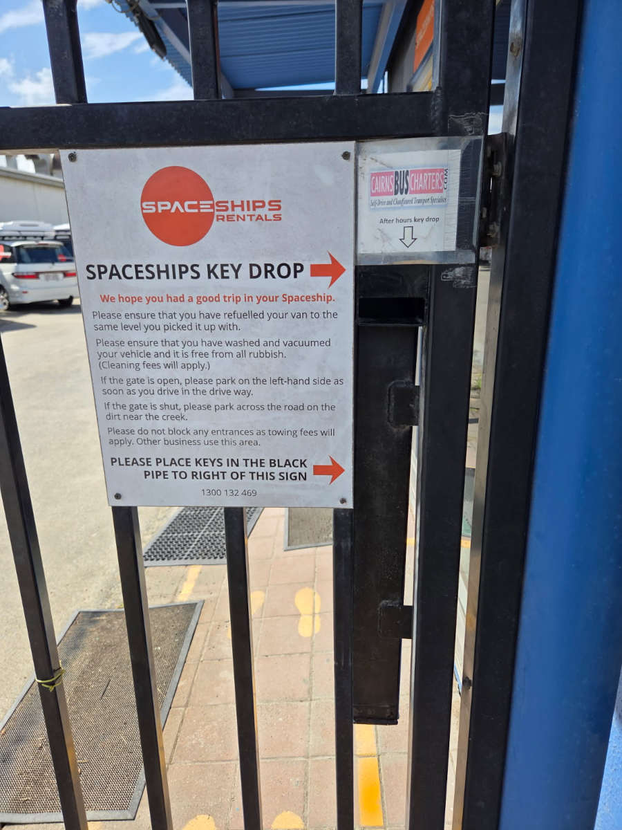 Key drop pipe on the front gate + Spaceships sign with drop-off instructions