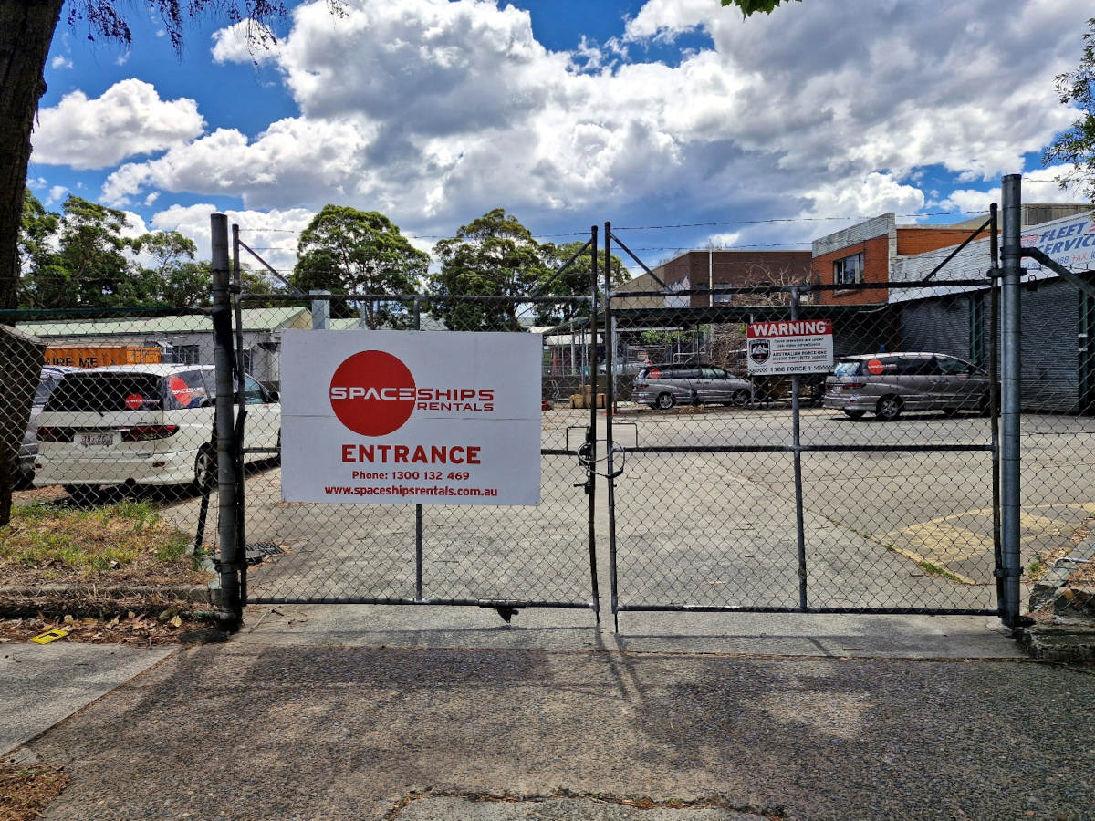 Entrance gate with sign at the Spaceships Sydney Depot
